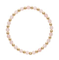 Gold filled armband van Bedels & Bedels met roze rozenkwarts kralen en gouden balletjes op witte achtergrond