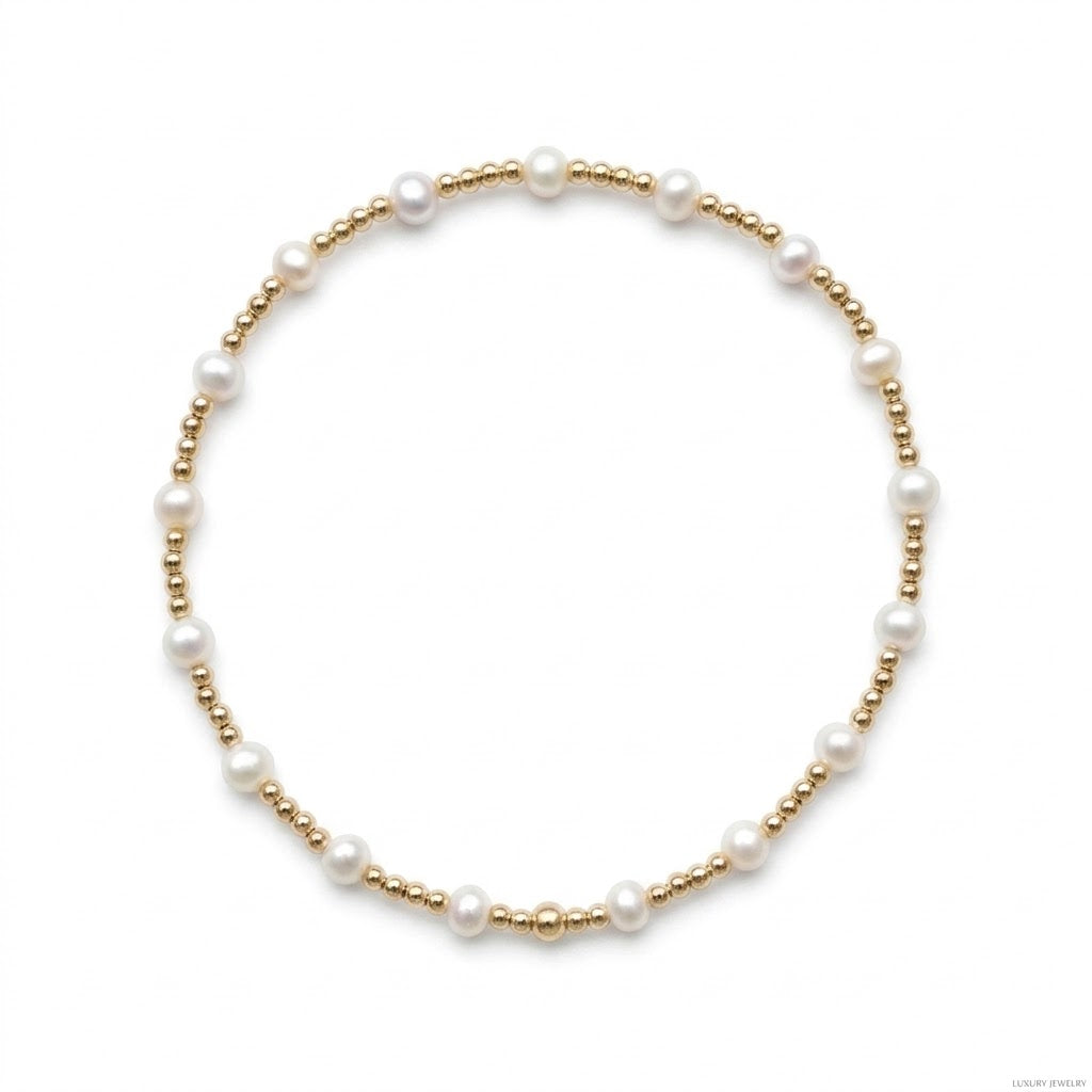 Fijne gouden kralenarmband van gold filled 14K met witte zoetwaterparels van 4mm, van Bedels & Bedels.