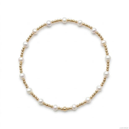 Fijne gouden kralenarmband van gold filled 14K met witte zoetwaterparels van 4mm, van Bedels & Bedels.
