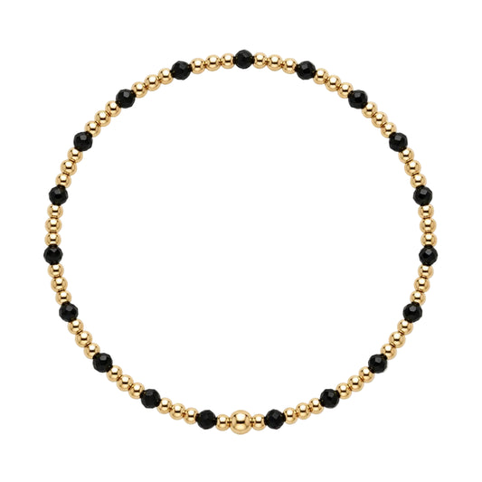 Gouden armband met gold filled kralen en zwarte spinel edelsteentjes, productfoto op witte achtergrond